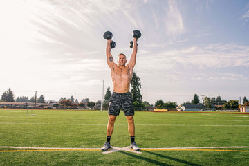 Man pressing two dumbbells overhead
