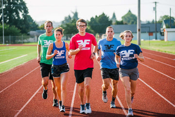 A group of young athletes running on track 