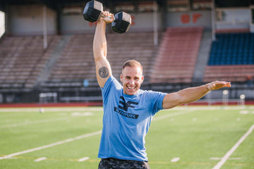 Man holding a dumbbell with right outstretched arm