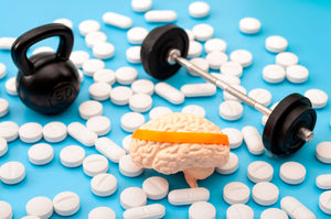 Kettlebell, barbell, brain and scattered pills